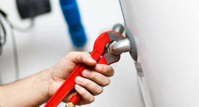 Heating Engineer Fixing Boiler During Boiler Service