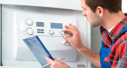 Central Heating Engineer Carrying out Boiler Service