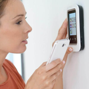 Woman Setting Her Thermostatic Radiator after Boiler Breakdown Service
